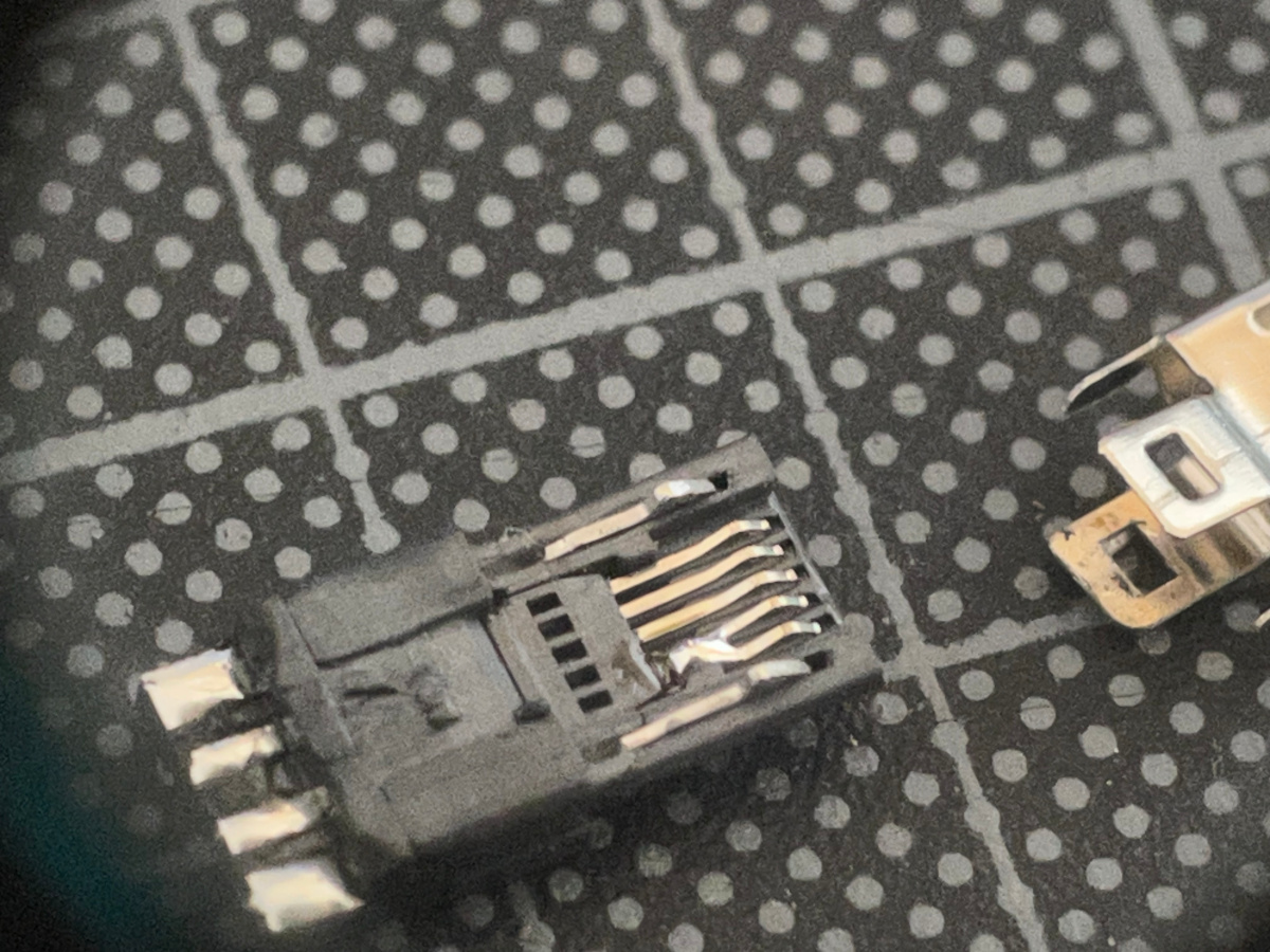 Disassembled micro USB connector with hard wire ID to GND